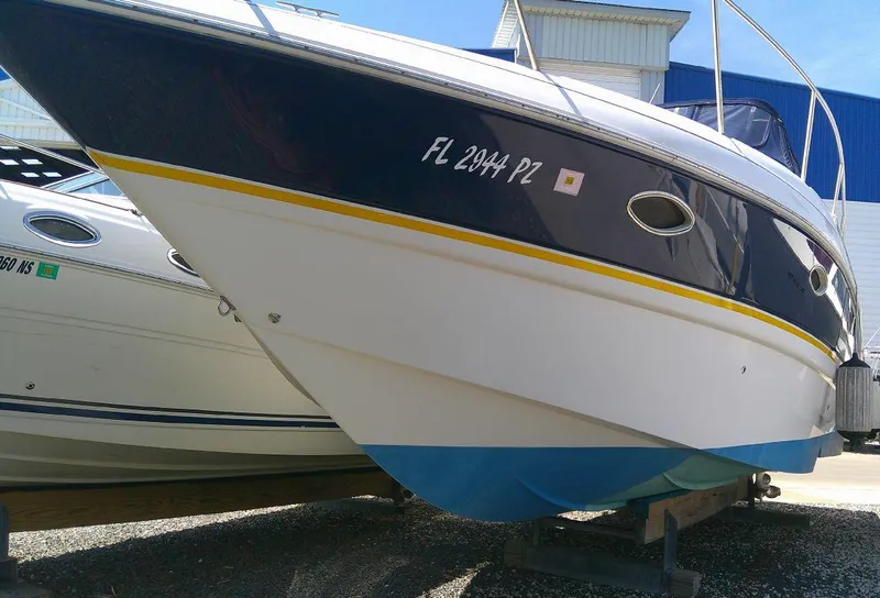 Slide: The Image of 2005 Larson Cabrio 330 boat on dry dock, side view. - 9