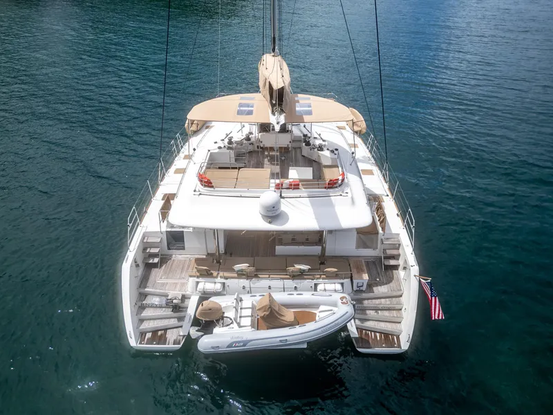 Slide: The Image of Lagoon 560 catamaran, 2012 model, anchored in calm blue waters, rear view. - 16