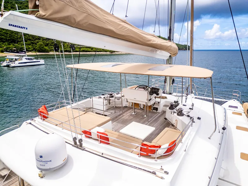 Slide: The Image of Lagoon 560 catamaran, 2012 model, docked in serene waters with spacious deck and seating area. - 22