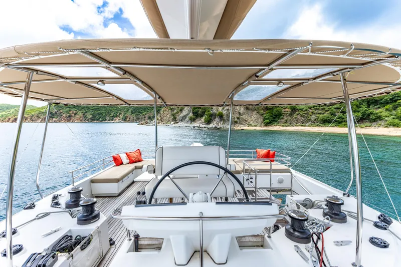 Slide: The Image of Luxurious 2012 Lagoon 560 yacht deck with helm, seating, and scenic ocean view. - 26