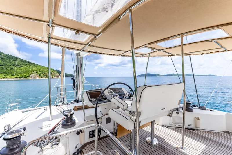 Slide: The Image of Lagoon 560 yacht cockpit with ocean view, 2012 model, featuring steering wheel and canopy. - 27