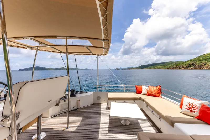 Slide: The Image of Luxurious Lagoon 560 yacht deck with seating, ocean view, and sunny skies. - 30