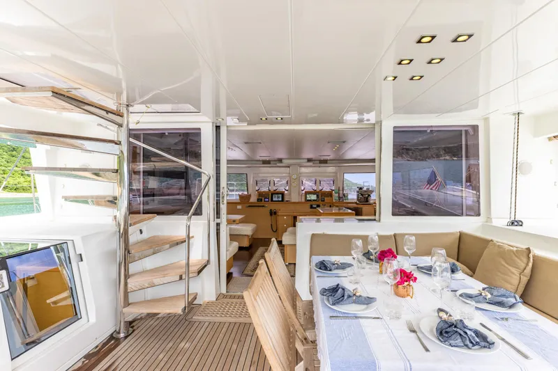 Slide: The Image of Luxurious interior of 2012 Lagoon 560 yacht with elegant dining area and spiral staircase. - 32