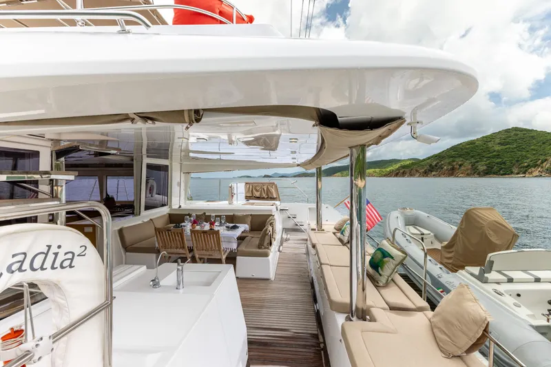 Slide: The Image of Luxurious 2012 Lagoon 560 yacht with spacious deck, dining area, and scenic ocean view. - 33