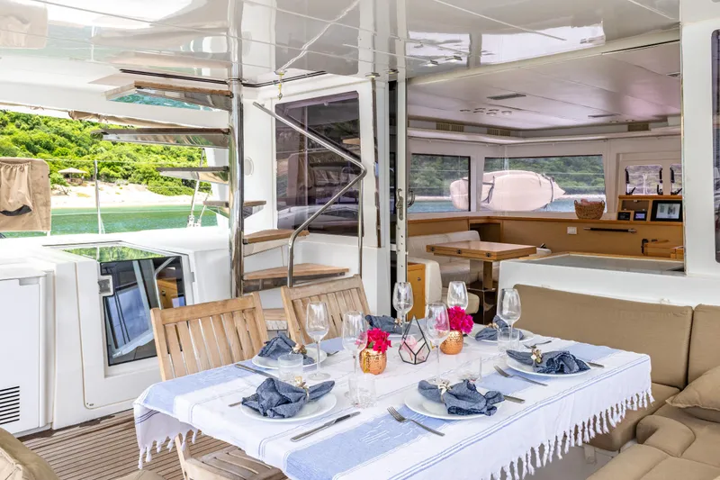 Slide: The Image of Luxurious Lagoon 560 yacht interior, elegantly set dining area, 2012 model. - 34