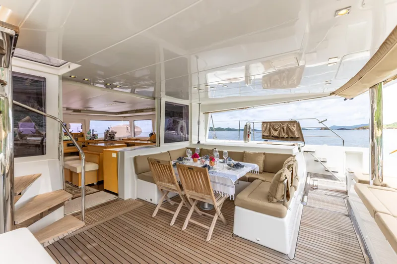 Slide: The Image of Luxurious Lagoon 560 yacht interior with dining area, wooden flooring, and ocean view, 2012 model. - 38