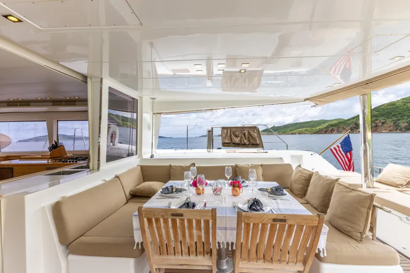 Slide: The Image of Luxurious Lagoon 560 yacht interior with elegant dining setup, 2012 model, ocean view. - 39