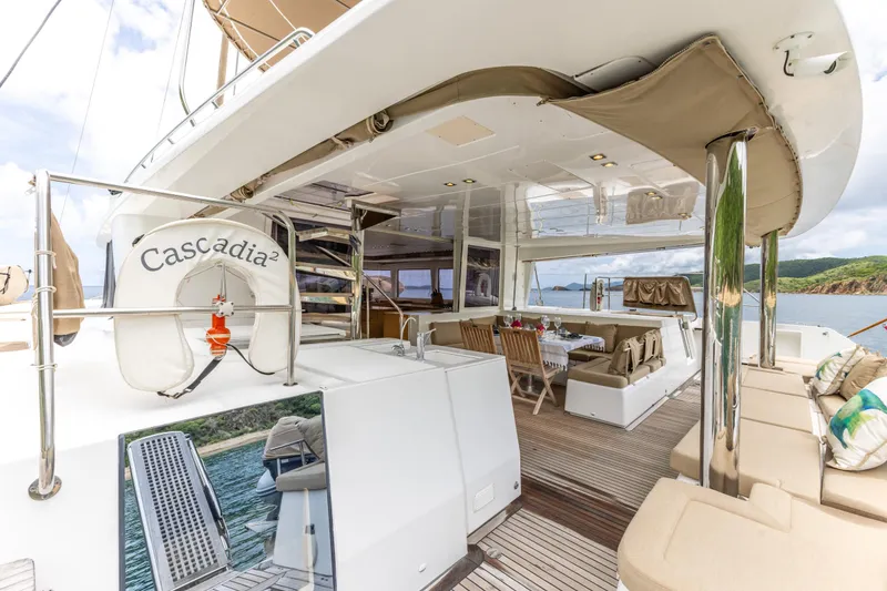 Slide: The Image of Luxurious 2012 Lagoon 560 yacht deck with seating, dining area, and scenic ocean view. - 40