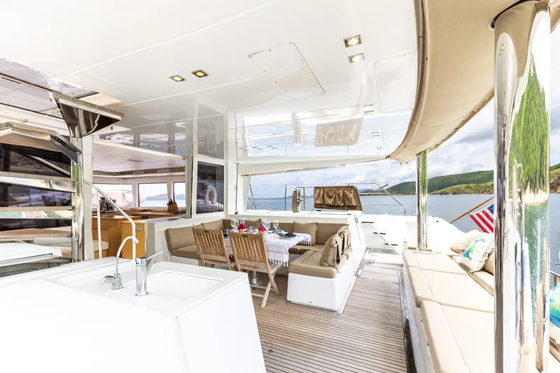 Slide: The Image of Luxurious Lagoon 560 yacht interior, featuring elegant seating and dining area, 2012 model. - 41