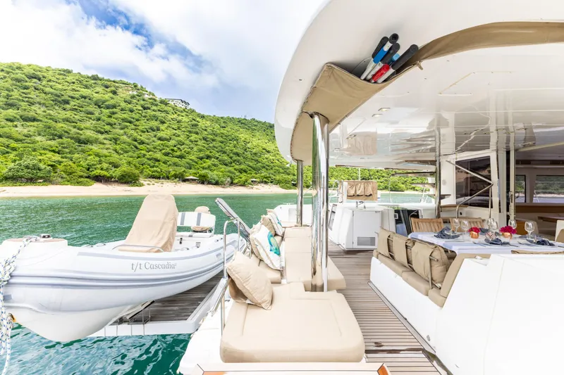Slide: The Image of Luxurious 2012 Lagoon 560 yacht with spacious deck, moored near lush green island. - 42