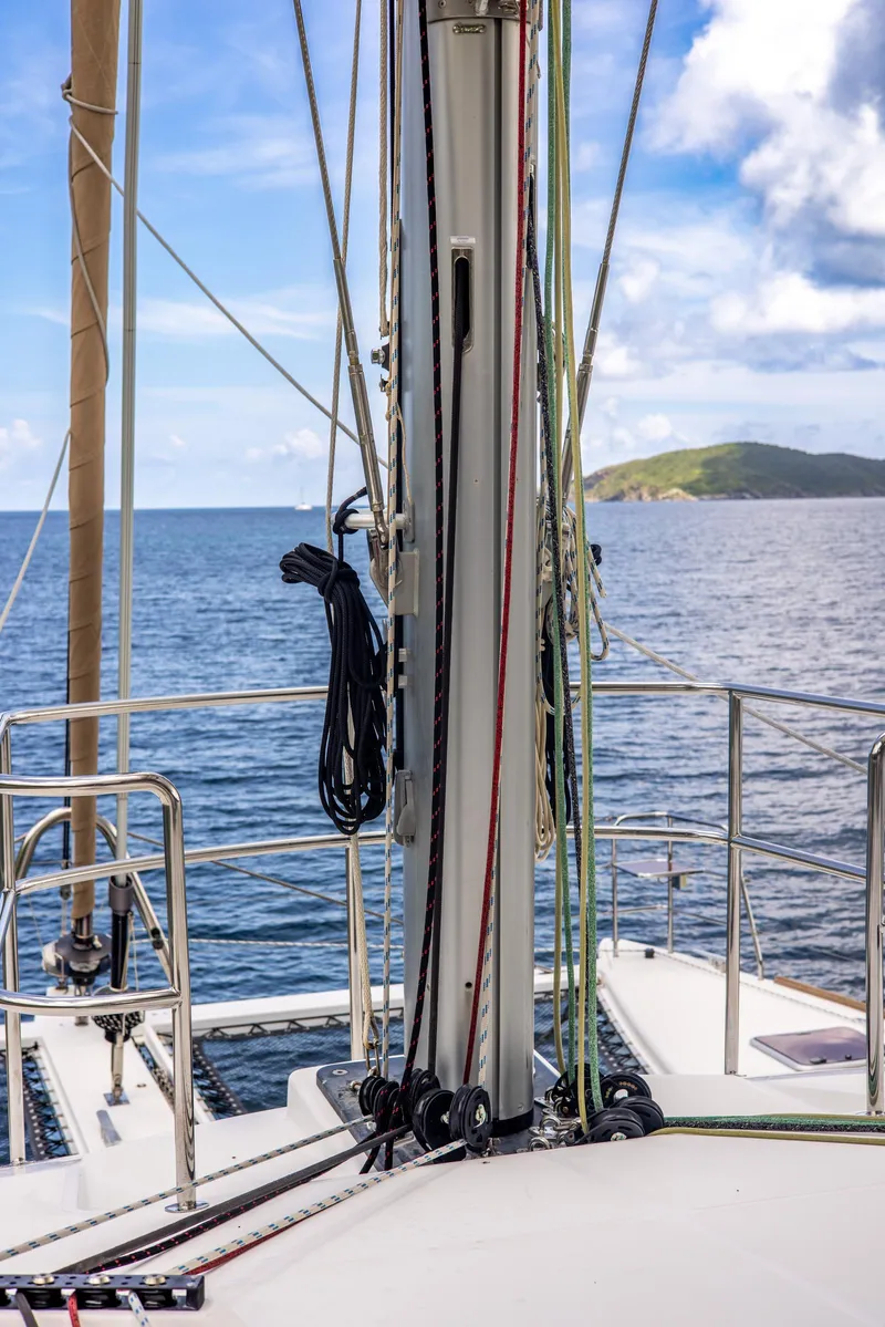 Slide: The Image of Lagoon 560 sailboat deck view, 2012 model, with ocean and island backdrop. - 46