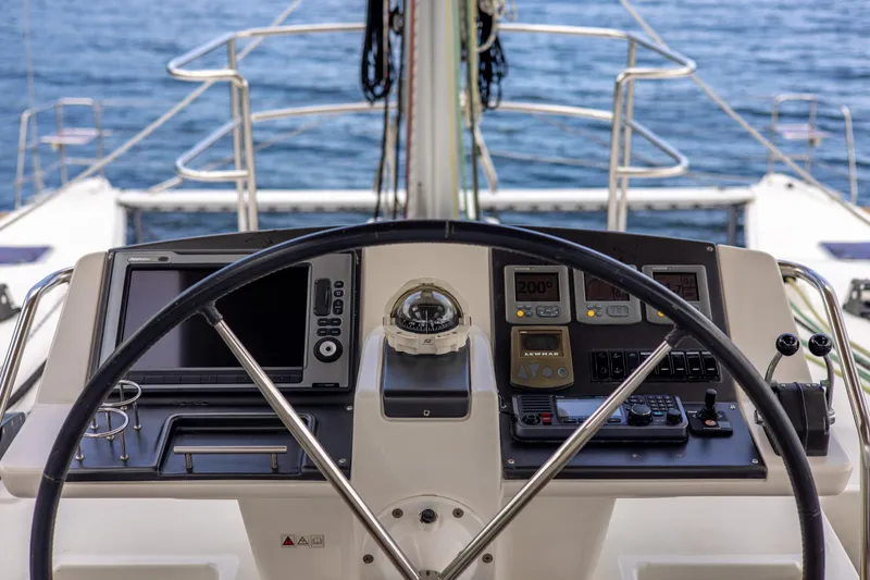 Slide: The Image of Helm of 2012 Lagoon 560 catamaran with navigation instruments and ocean view. - 47
