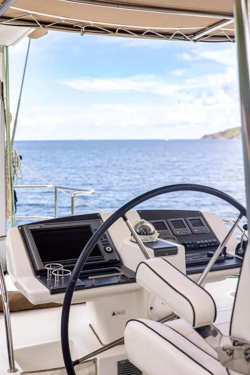 Slide: The Image of Helm of 2012 Lagoon 560 catamaran with ocean view and modern navigation equipment. - 48