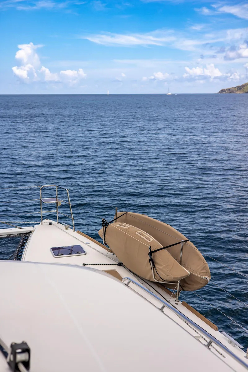 Slide: The Image of Lagoon 560 yacht on open sea, 2012 model, with clear blue sky and calm waters. - 49
