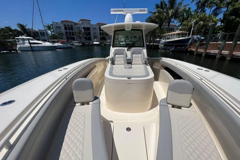 Slide: The Image of 2024 Scout 355 LXF luxury boat docked in a marina. - 14