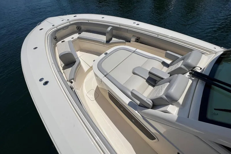 Slide: The Image of 2024 Scout 355 LXF boat with luxurious seating and spacious deck. - 15