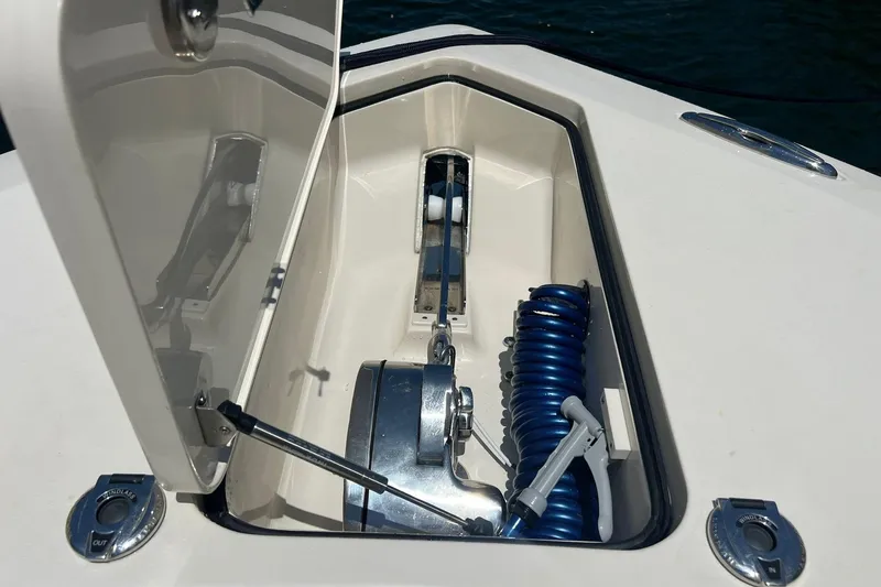 Slide: The Image of 2024 Scout 355 LXF anchor locker with coiled hose and anchor winch. - 17