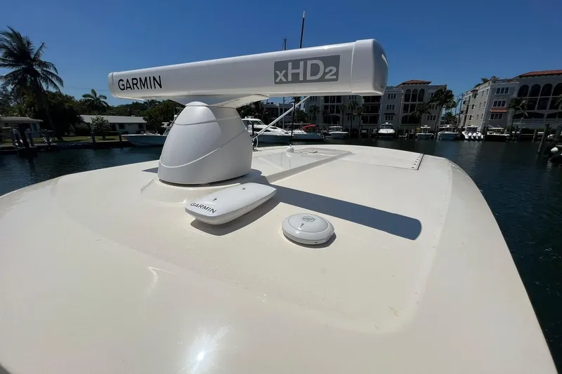 Slide: The Image of 2024 Scout 355 LXF boat with Garmin xHD2 radar in marina. - 18