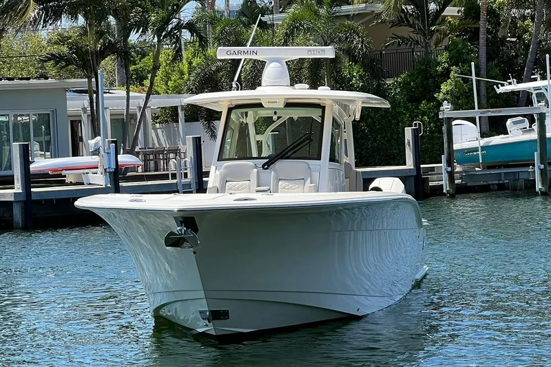 Slide: The Image of 2024 Scout 355 LXF boat docked in a marina. - 3