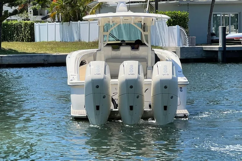 Slide: The Image of 2024 Scout 355 LXF boat with triple outboard engines on the water. - 5