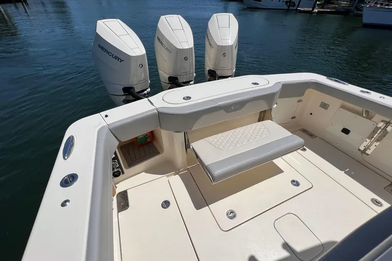 Slide: The Image of 2024 Scout 355 LXF boat with triple Mercury engines. - 7