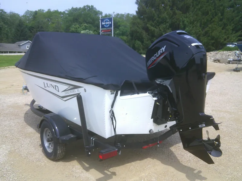 Slide: The Image of 2024 Lund 1650 Rebel XL Sport boat with Mercury outboard motor, covered and on trailer. - 15