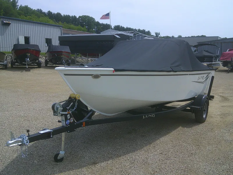 Slide: The Image of 2024 Lund 1650 Rebel XL Sport boat on trailer with cover in outdoor lot. - 16