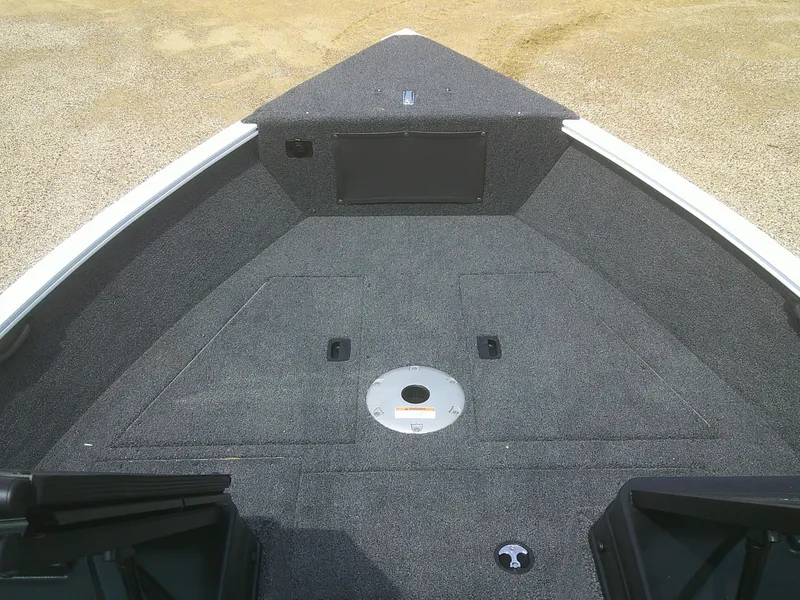 Slide: The Image of 2024 Lund 1650 Rebel XL Sport boat bow with carpeted deck and storage compartments. - 3
