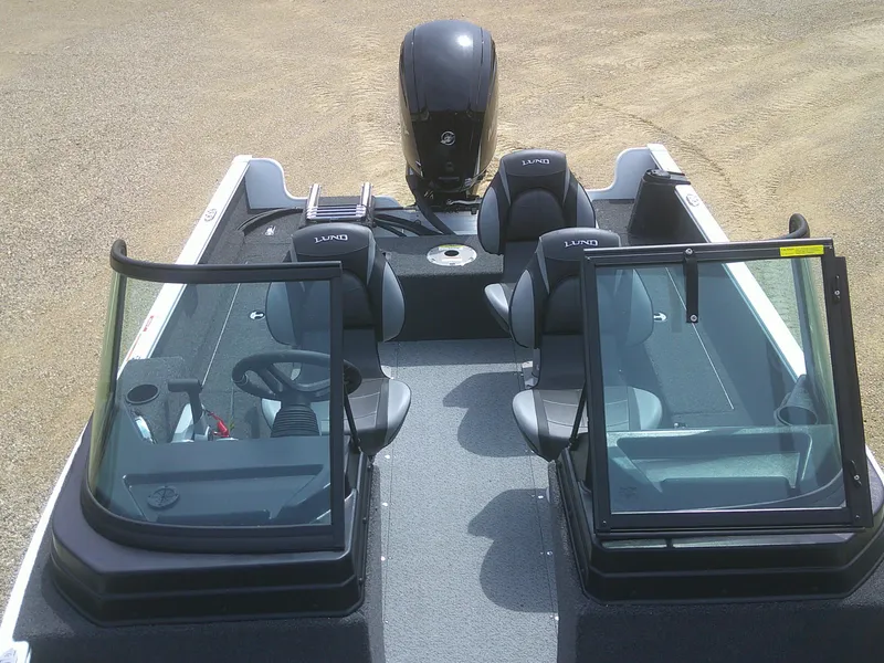 Slide: The Image of 2024 Lund 1650 Rebel XL Sport boat interior with seating and windshield. - 6