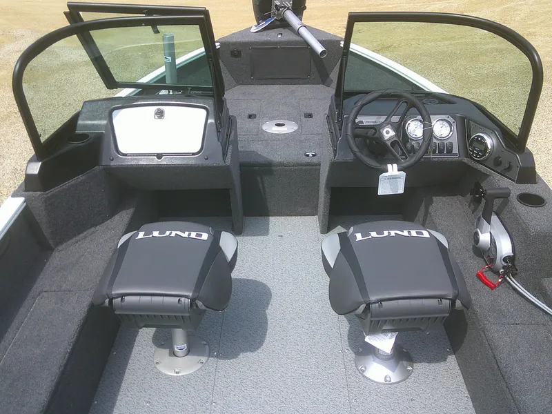 Slide: The Image of 2024 Lund 1650 Rebel XL Sport boat interior with two seats and steering console. - 7