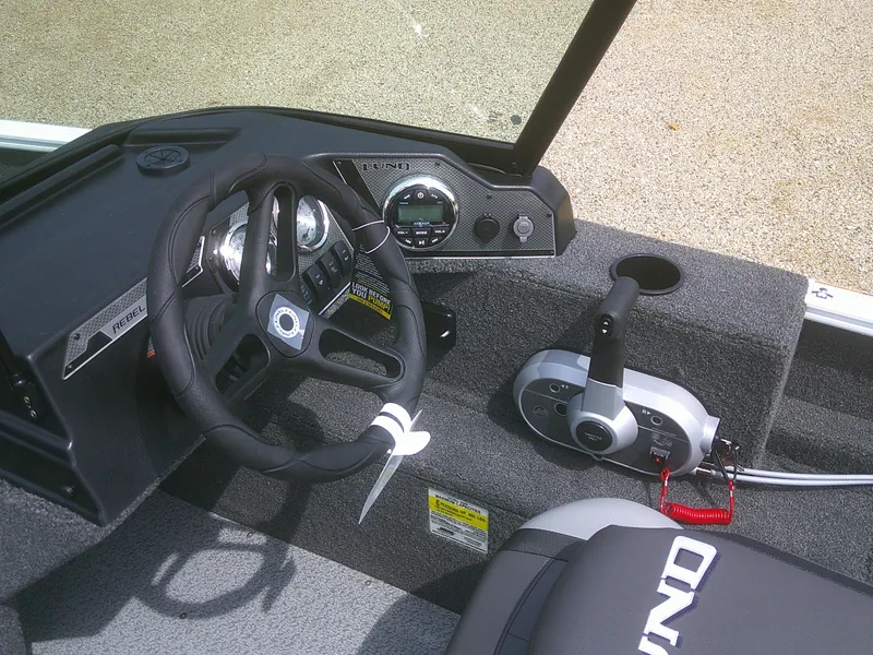 Slide: The Image of 2024 Lund 1650 Rebel XL Sport boat dashboard and controls. - 9