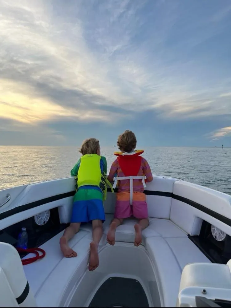 Slide: The Image of Children enjoying sunset on a 2015 Sea Ray 250 SLX boat. - 12