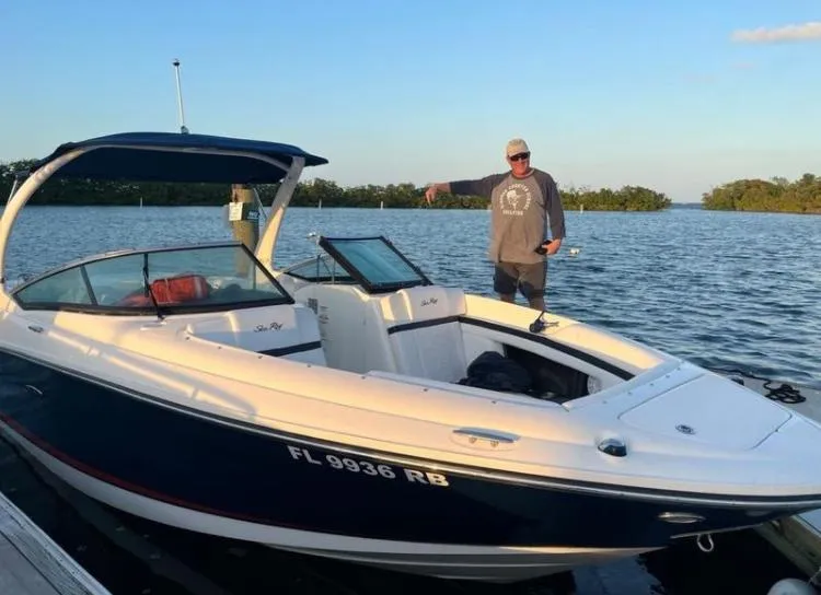 Slide: The Image of Man standing on dock next to 2015 Sea Ray 250 SLX boat in water. - 4
