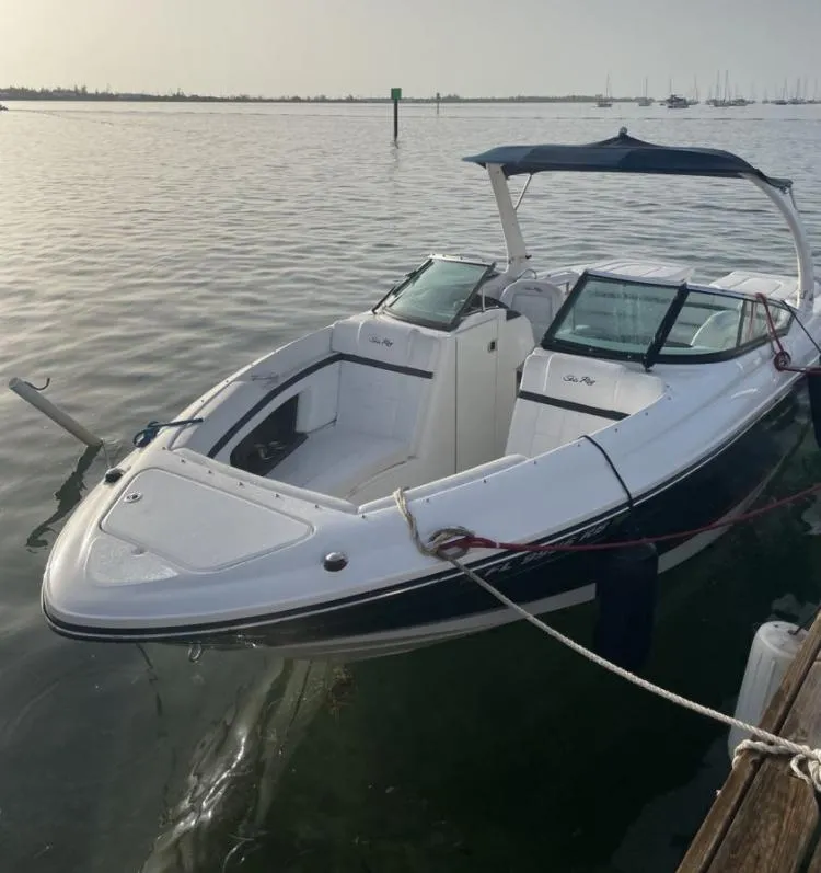 Slide: The Image of 2015 Sea Ray 250 SLX boat docked on calm water. - 5