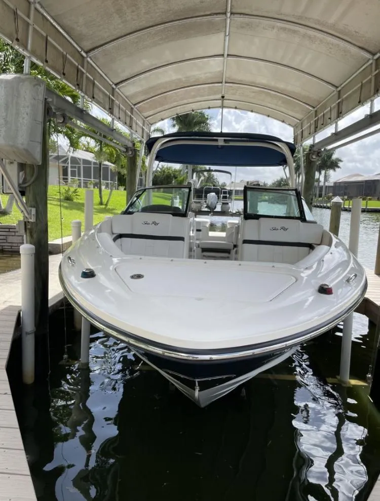 Slide: The Image of 2015 Sea Ray 250 SLX boat docked under a canopy. - 7