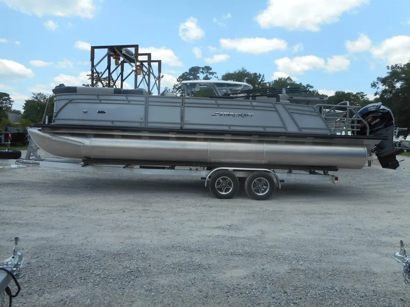 The Image of 2024 Starcraft CX 25 DL BAR pontoon boat on a trailer. - 0