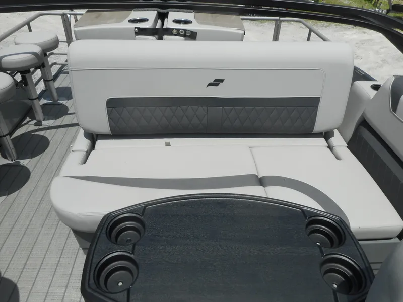 Slide: The Image of 2024 Starcraft CX 25 DL BAR boat interior with cushioned seating and cup holders. - 3