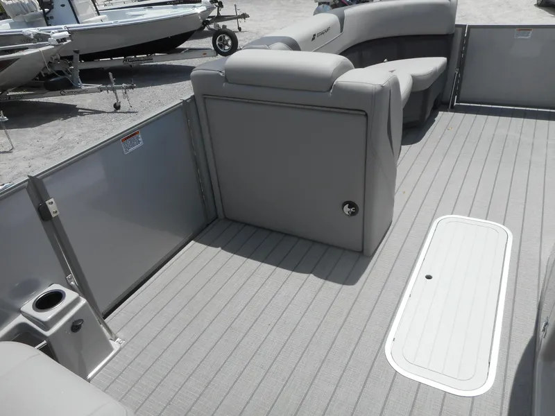 Slide: The Image of 2024 Starcraft CX 25 DL BAR pontoon boat interior with gray seating and flooring. - 7