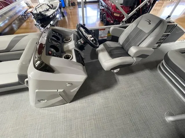 Slide: The Image of 2024 Bennington 21SXSB boat interior with captain's chair and control console. - 6