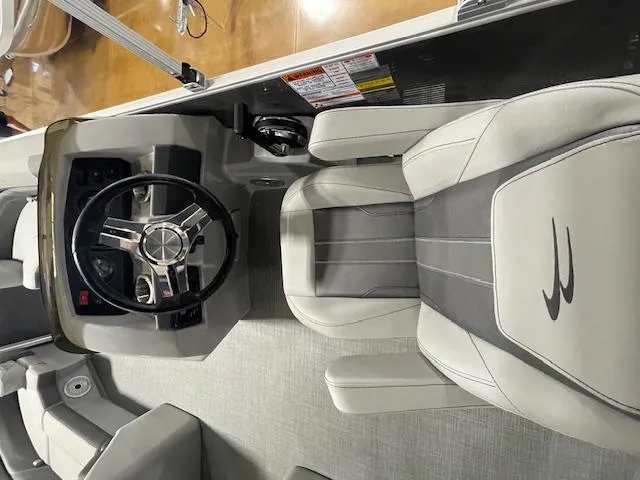 Slide: The Image of 2024 Bennington 21SXSB boat interior with steering wheel and captain's chair. - 7