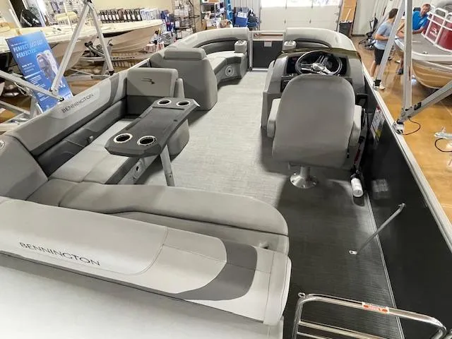 Slide: The Image of 2024 Bennington 21SXSB pontoon boat interior with gray seating and helm station. - 8