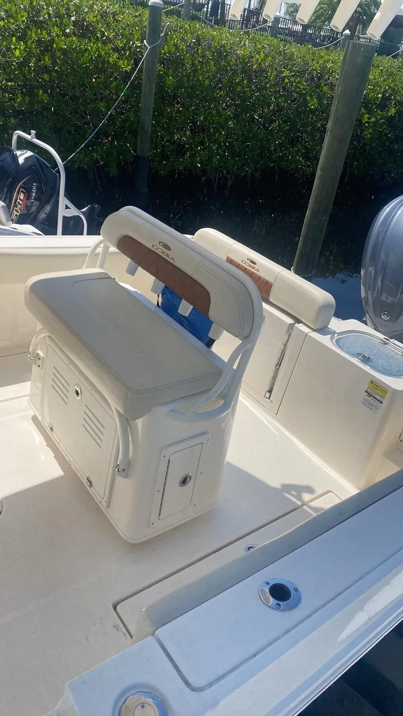 Slide: The Image of 2023 Cobia 237 Center Console boat interior with cushioned seating and storage. - 4