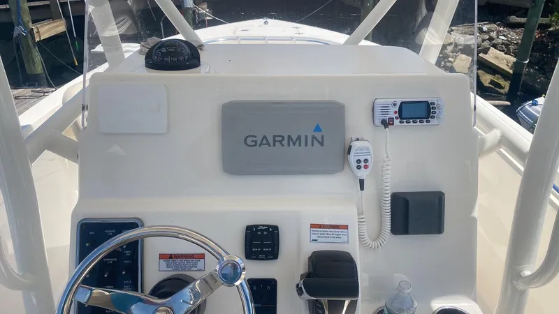 Slide: The Image of 2023 Cobia 237 Center Console boat dashboard with Garmin navigation system. - 8