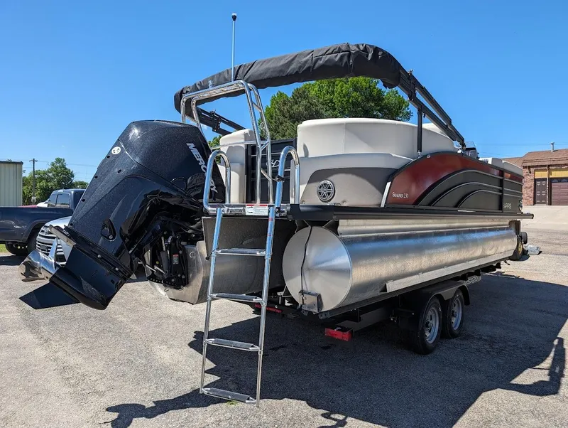 Slide: The Image of 2024 Harris FloteBote Sunliner 230 CWDH pontoon boat with outboard motor and ladder. - 7
