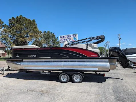 Slide: The Image of 2024 Harris FloteBote Sunliner 230 CWDH pontoon boat on trailer at Waconda Boats dealership. - 1