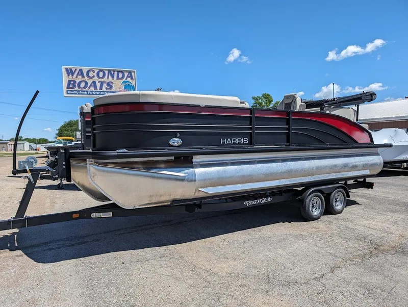 Slide: The Image of 2024 Harris FloteBote Sunliner 230 CWDH pontoon boat on trailer at Waconda Boats dealership. - 2