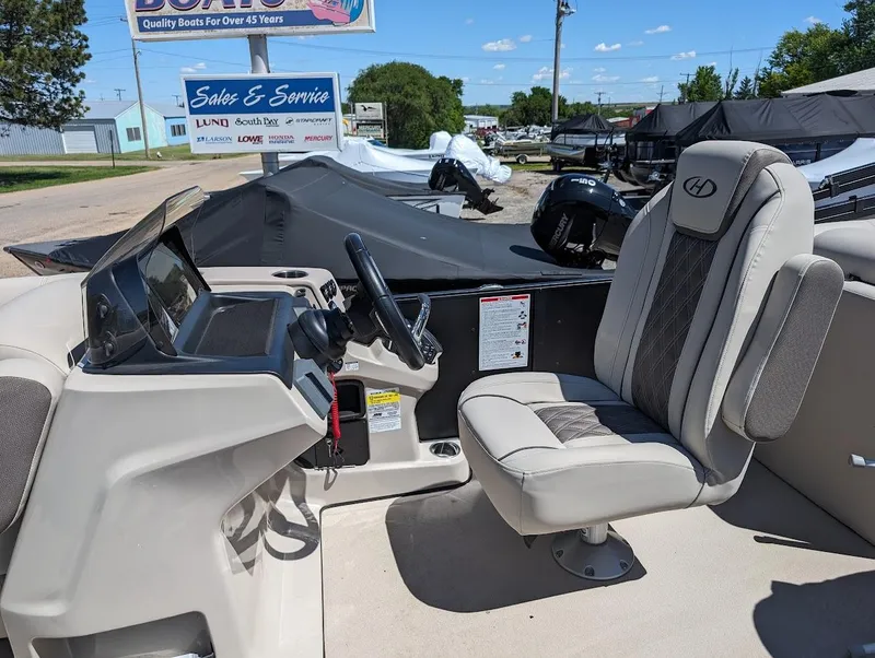 Slide: The Image of 2024 Harris FloteBote Sunliner 230 CWDH pontoon boat cockpit with captain's chair. - 5