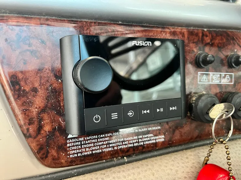 Slide: The Image of 2007 Four Winns 358 Vista dashboard with Fusion stereo system and ignition keys. - 13