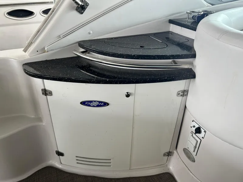 Slide: The Image of 2007 Four Winns 358 Vista boat interior with black countertop and storage cabinet. - 5