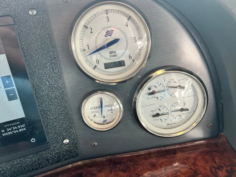Slide: The Image of 2007 Four Winns 358 Vista boat dashboard with RPM, rudder angle, and fuel gauges. - 11